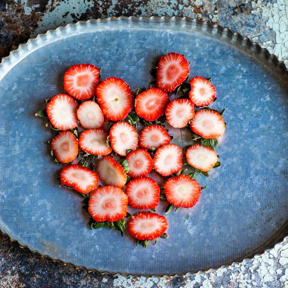 strawberry slices on oval scalloped metal tray