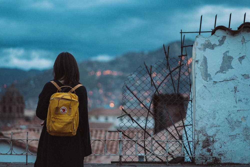 woman carrying brown backpack