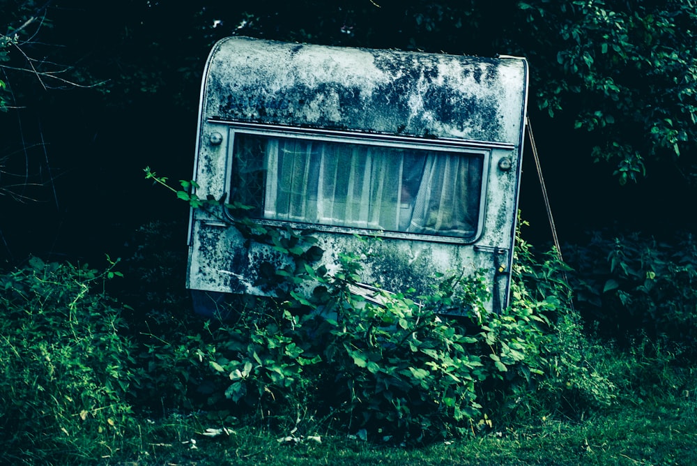 selective focus photography of abandon travel trailer