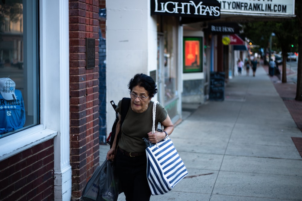 Foto de niña cargando una bolsa al lado del edificio durante el día –  Imagen gratuita Humano en Unsplash