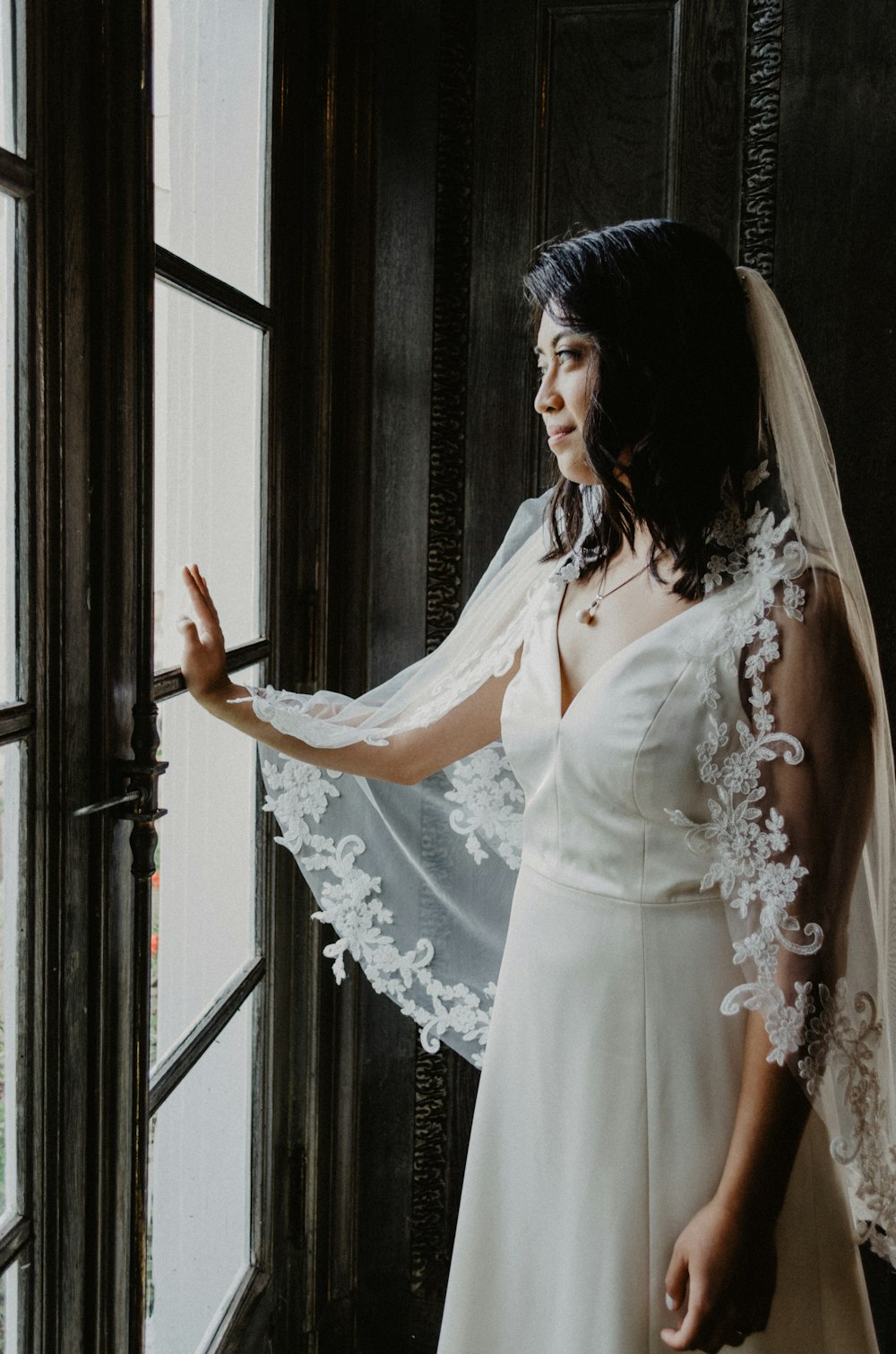 woman wearing white wedding gown with veil