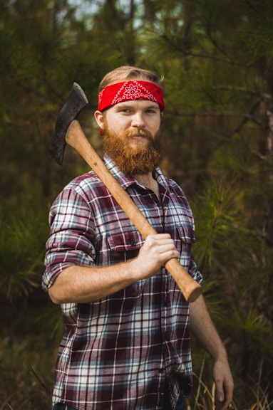 man carrying double-head axe