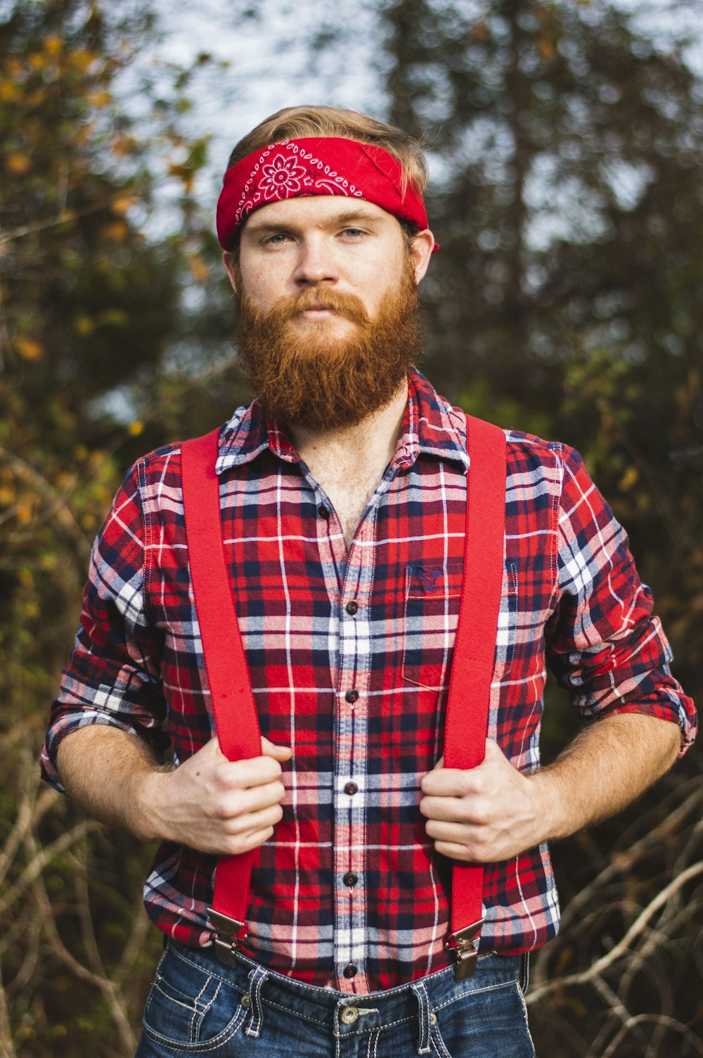 standing man wearing red and white floral kerchief close-up photo