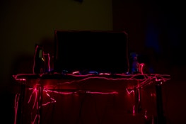 Clean and futuristic print and scan station with neon accents in a dark-themed room.