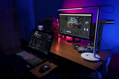 A serene workspace with a laptop open to the website page 'Lagniappe' featuring the embedded playlist and video.