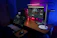 A cozy, modern creator workspace with warm LED lighting and sleek audiovisual gear.