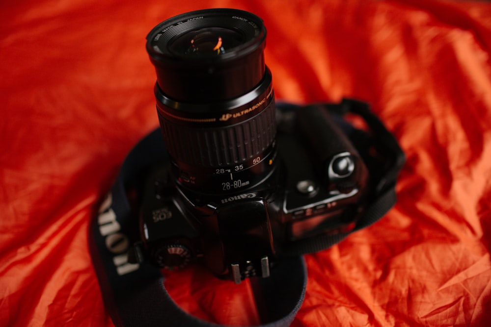 black Canon camera on red surface