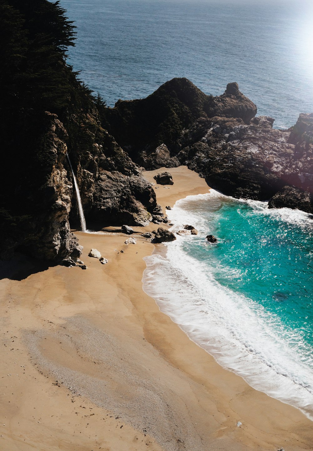 water flowing from the rocks towards the sea