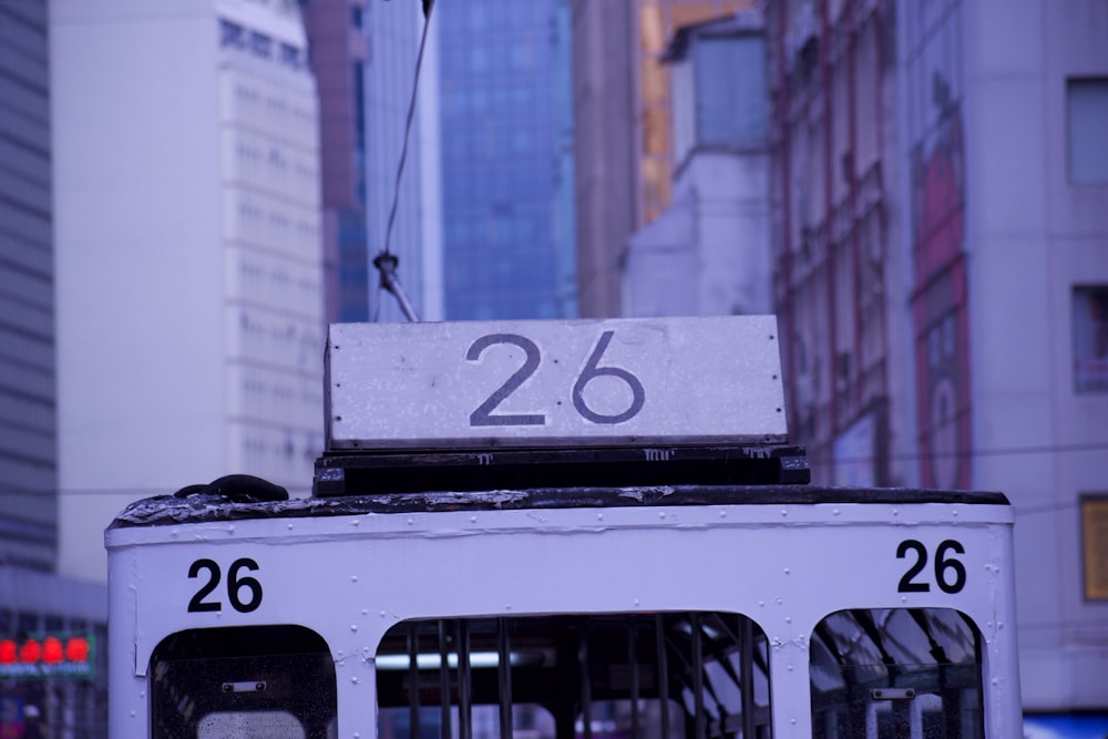 white cable car with 26 number on focus photography