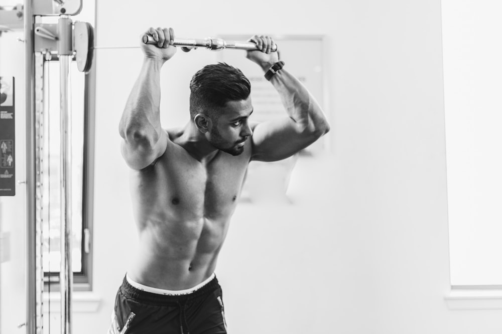 grayscale photo of man in gym