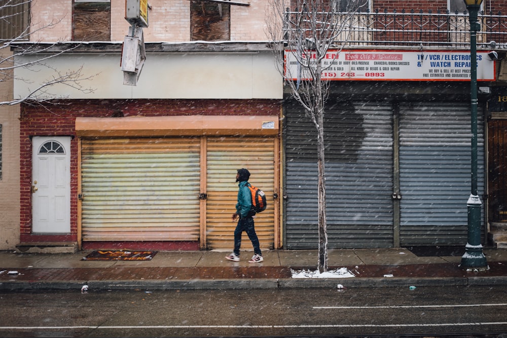 man walking near brown and gray concrete building during daytime