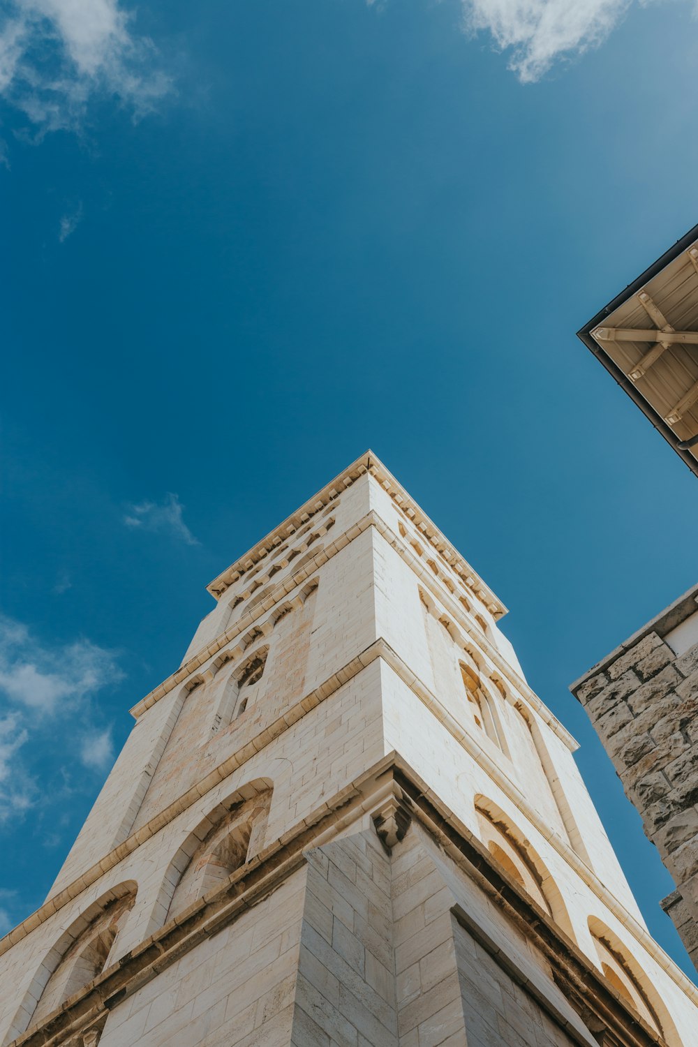 white concrete building during daytime low-angle photography