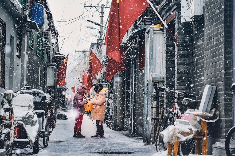 two person standing near houses