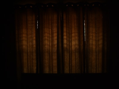 Close-up of elegant blackout curtains blocking sunlight in a cozy living room.
