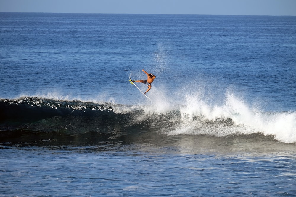 man surfboarding during daytime