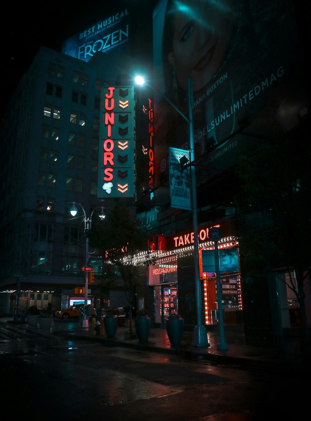 empty road between buildings at night time