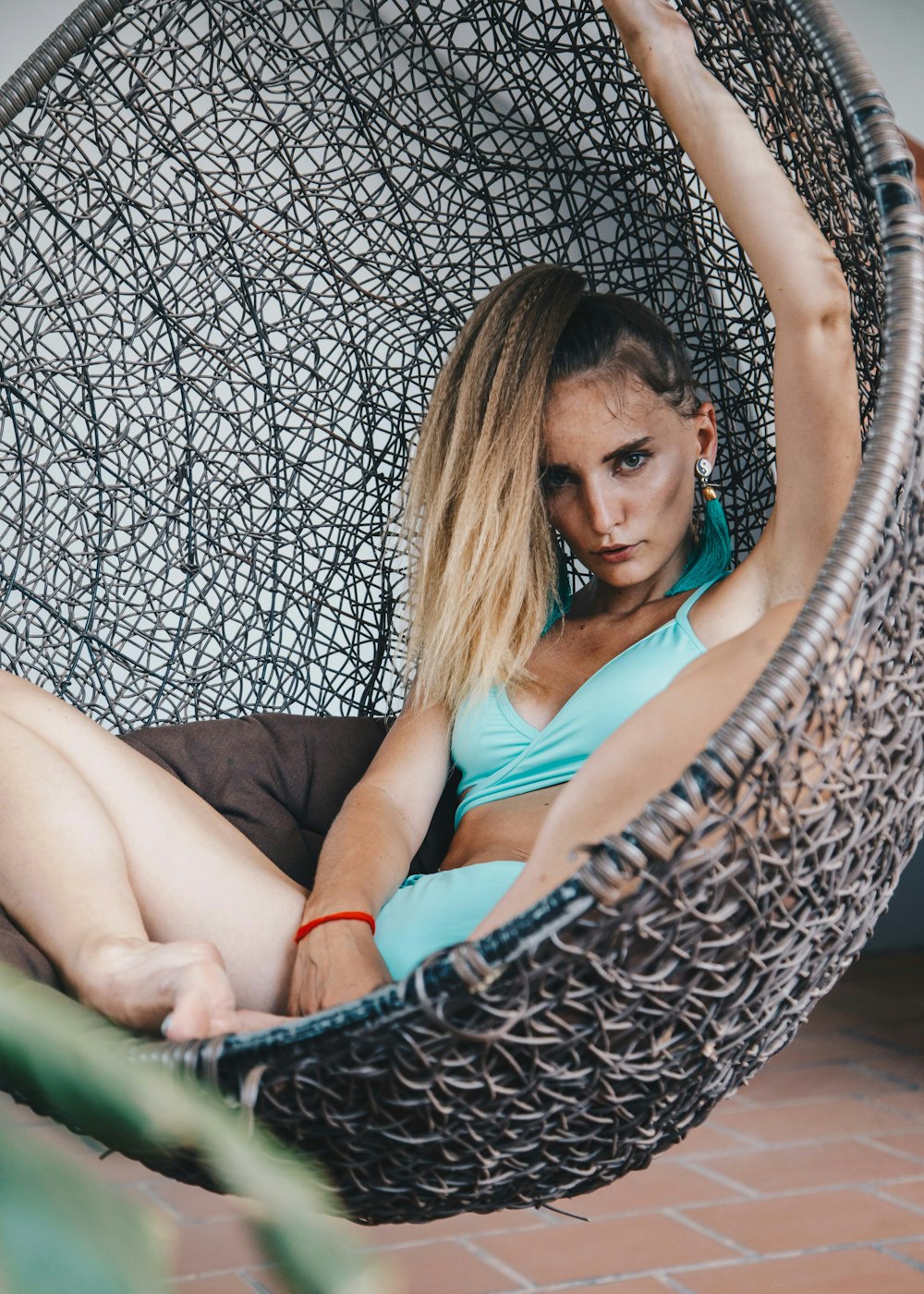 woman sitting on egg chair