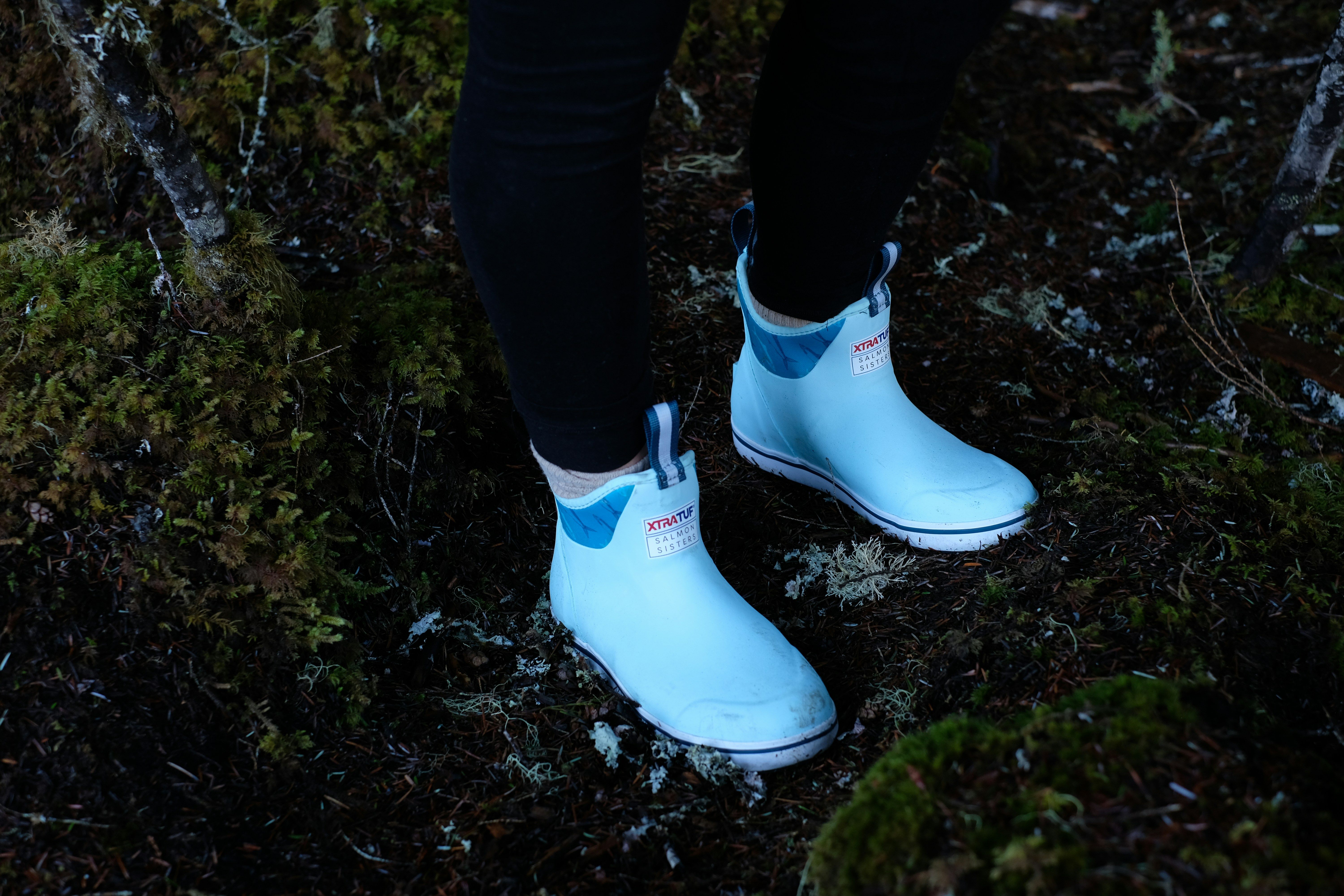 standing person wearing black pants and white sneakers