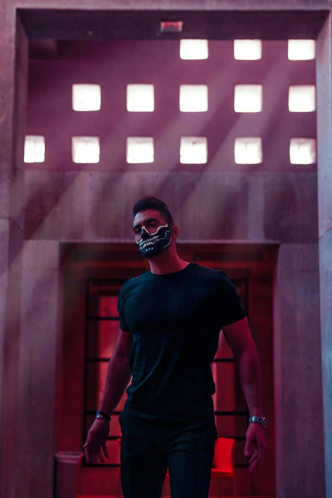 man wearing black crew-neck t-shirt and skull mask