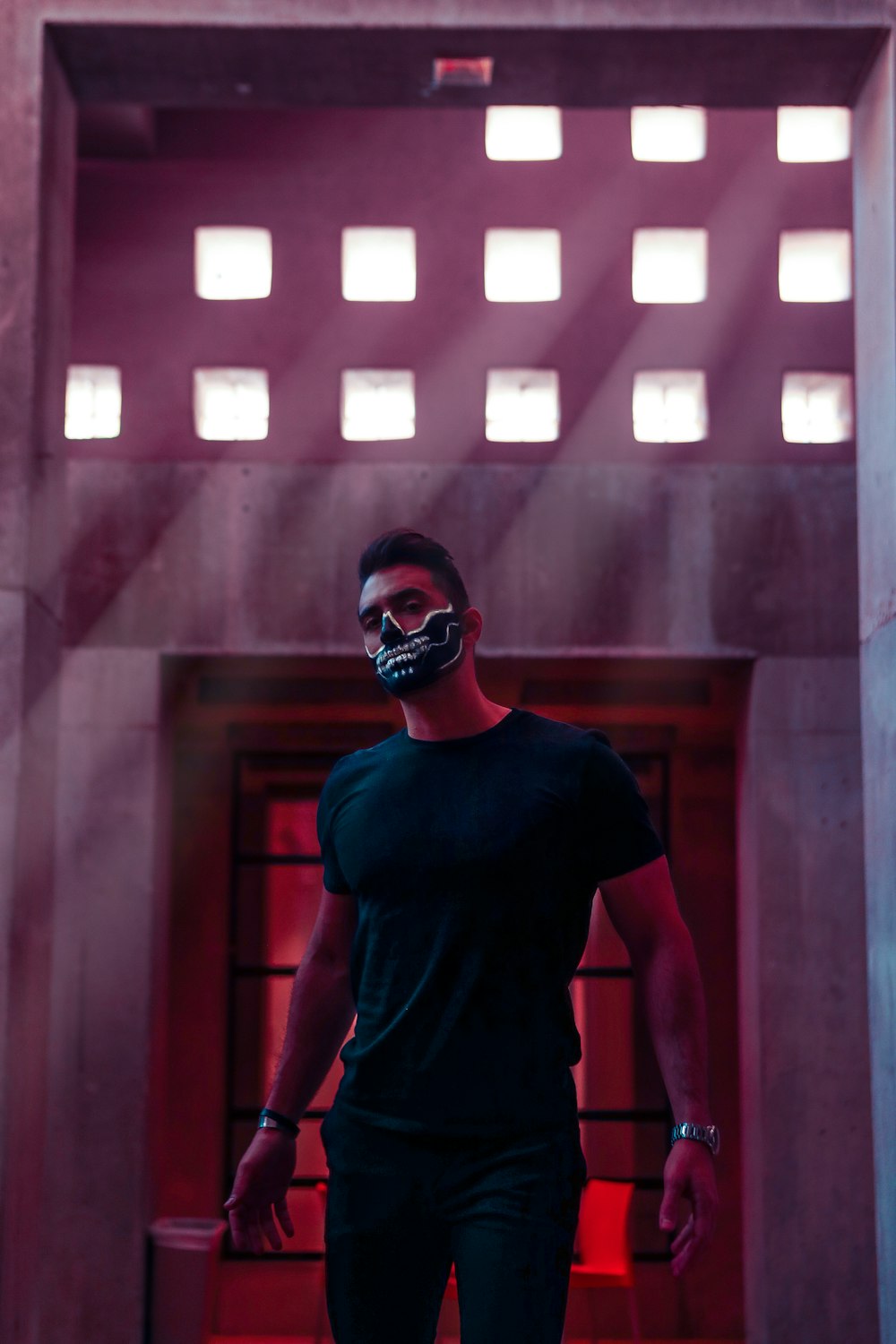 man wearing black crew-neck t-shirt and skull mask