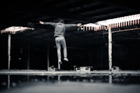 man jumping inside building