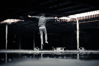 man jumping inside building