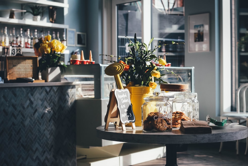 yellow tuips in vase on top of table