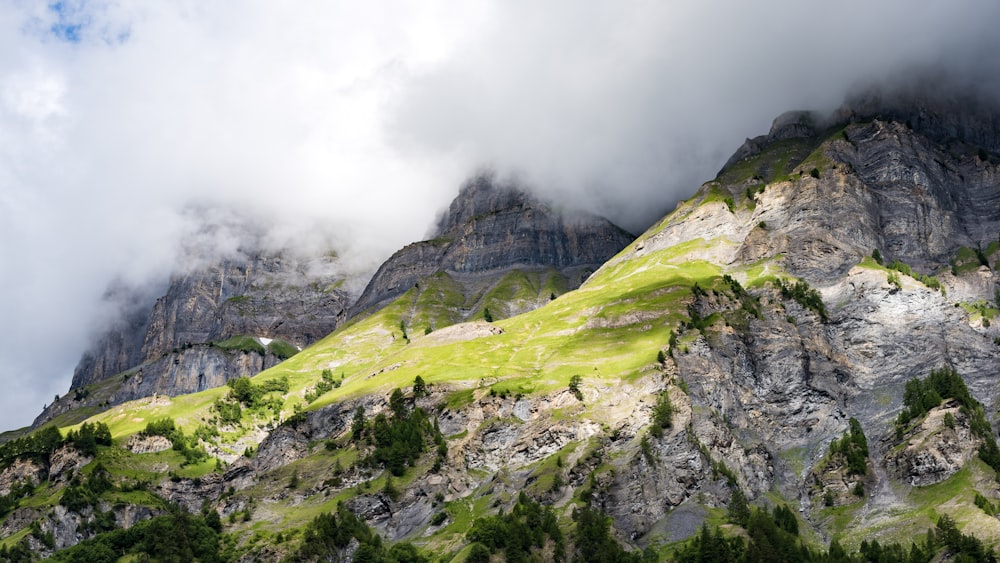 green and gray mountain under white clouds during daytime