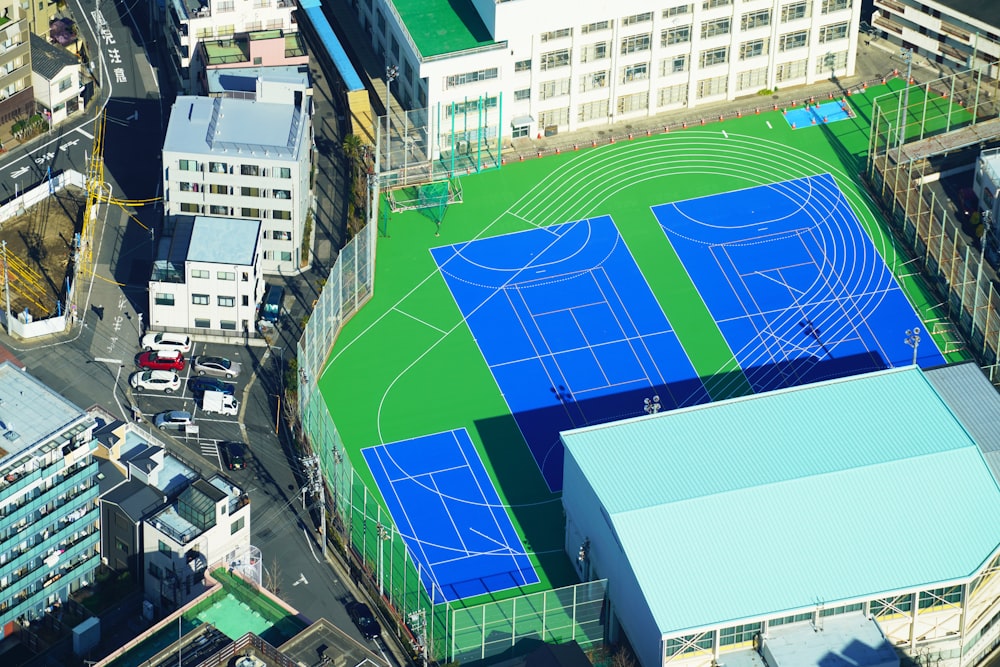 green and blue stadium in aerial photography