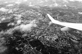 Aerial view showing a cityscape from a high tower with planes flying overhead.