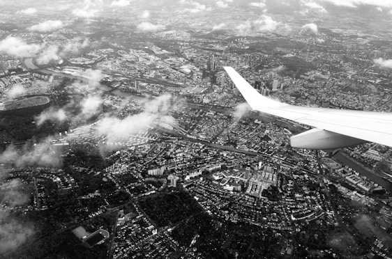 Aerial view showing a cityscape from a high tower with planes flying overhead.