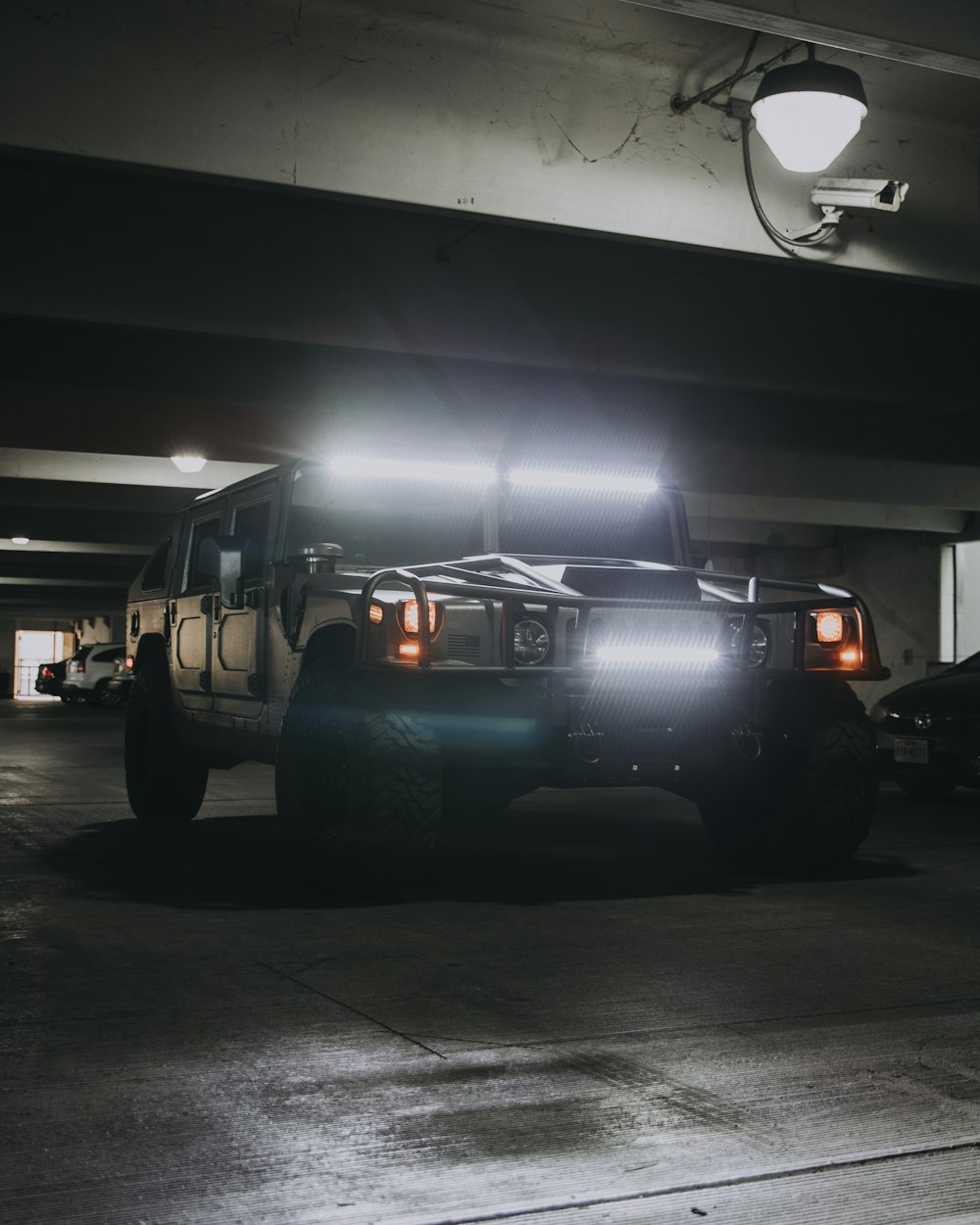 gray Hummer H1 SUV on concrete pavement