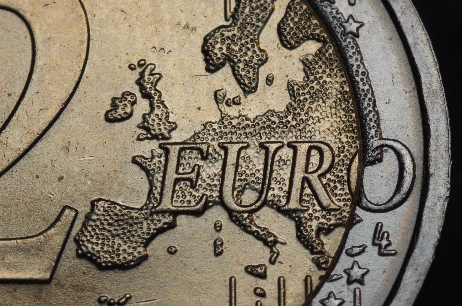 A pile of euro coins next to a receipt