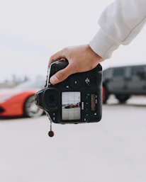 person holding black DSLR camera
