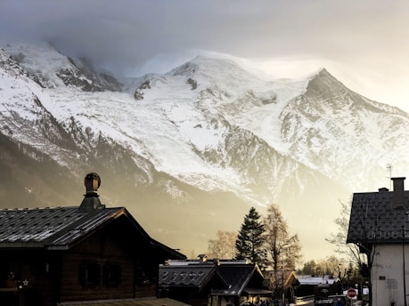 houses facing snow-covered mountains