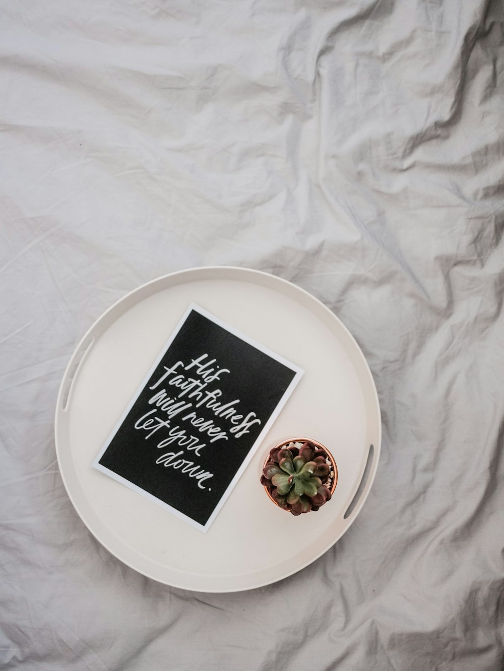 empty round white plate on white textile