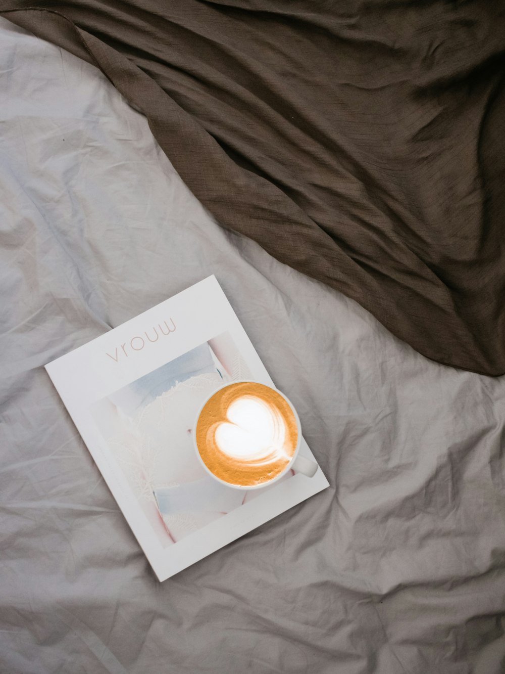 white ceramic cup on white labeled book