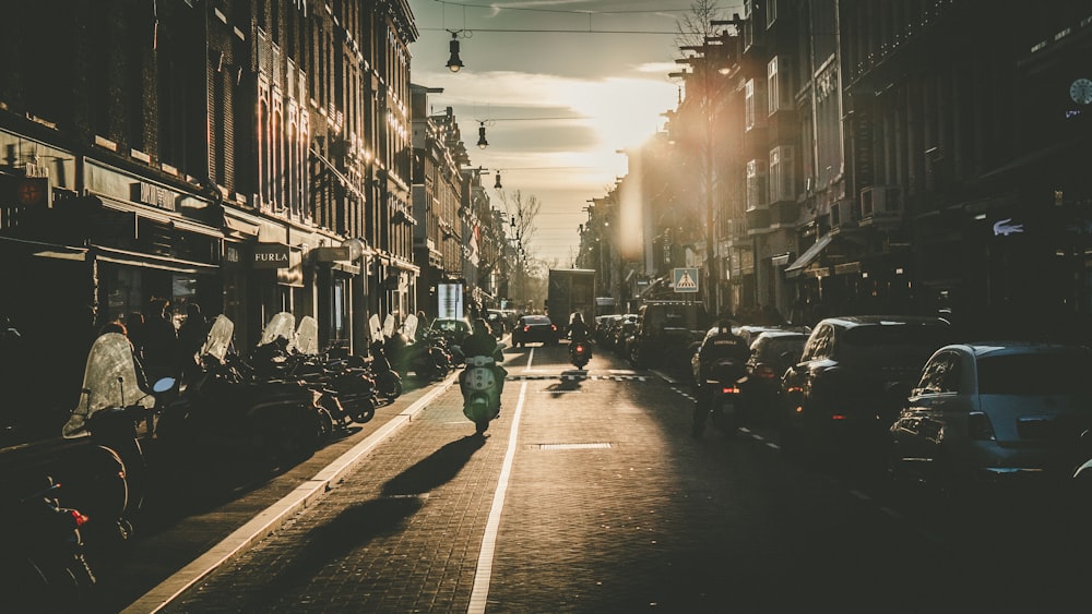 person riding motorcycle on road during golden hour