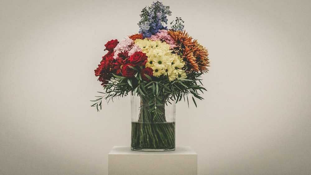 bouquet of red roses, yellow chrysanthemum and baby's breath flowers in vase