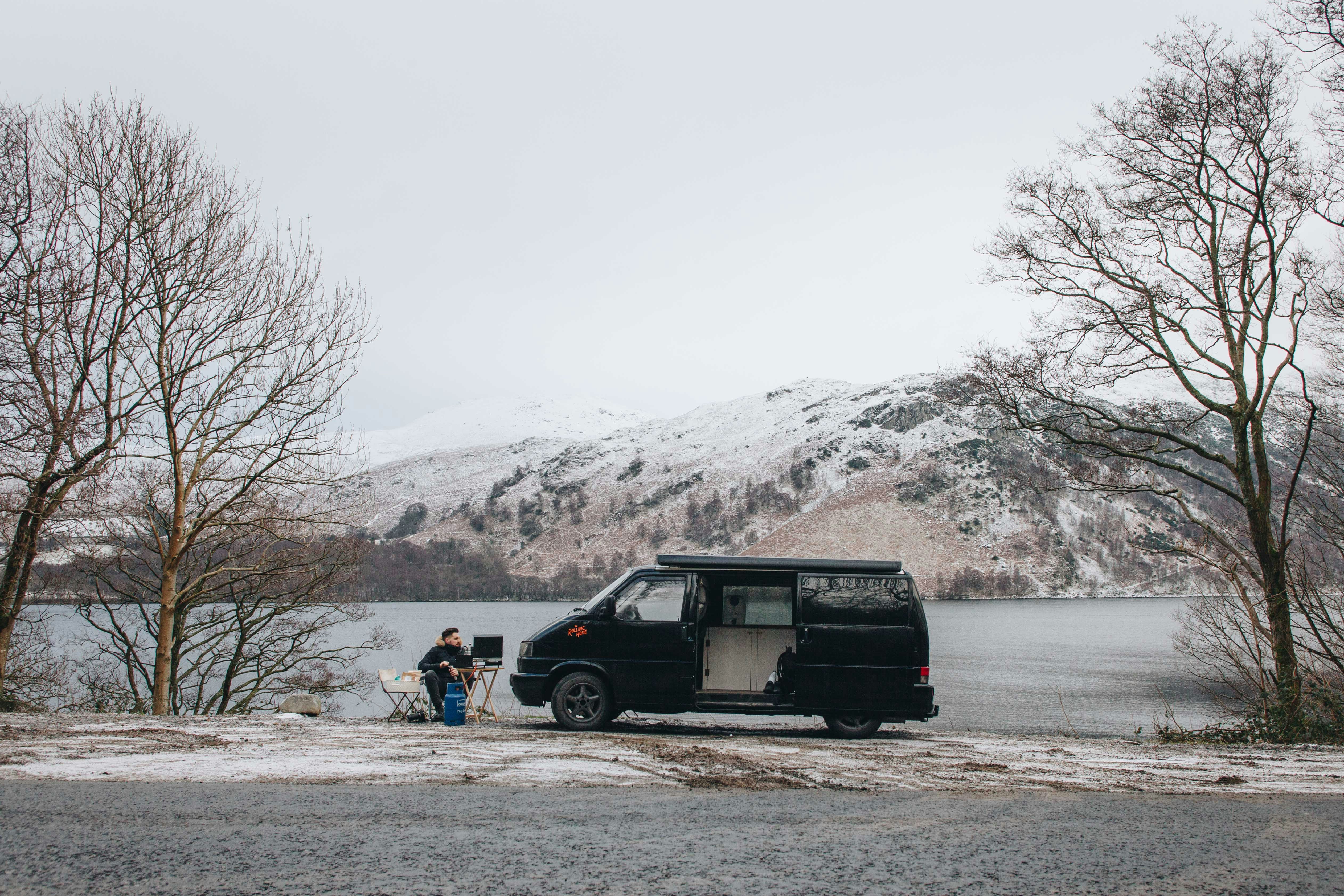 man sitting near van
