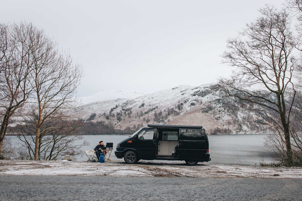 man sitting near van