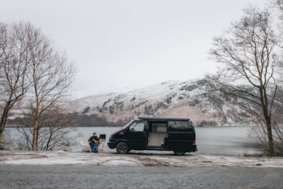 man sitting near van
