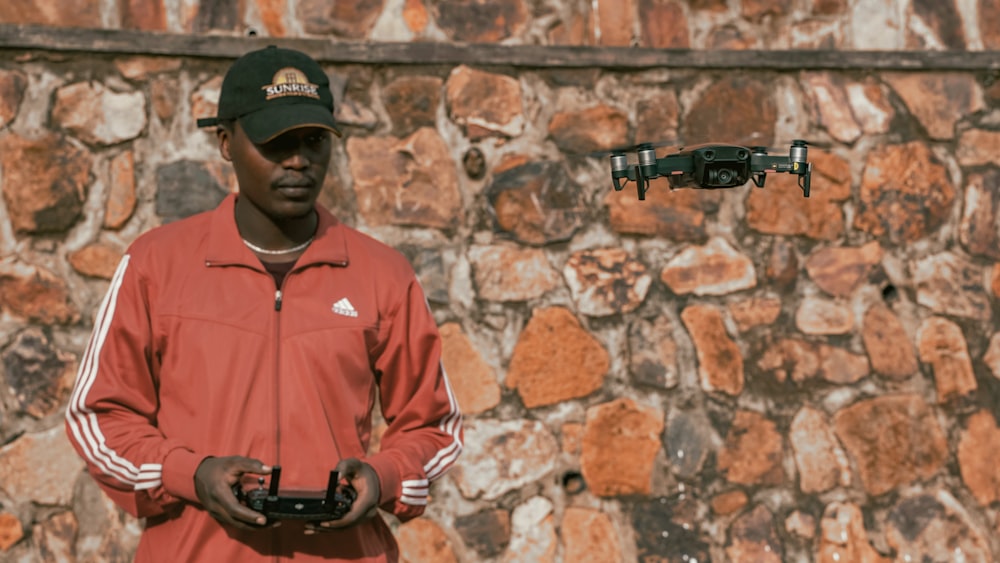 man controlling drone during daytime