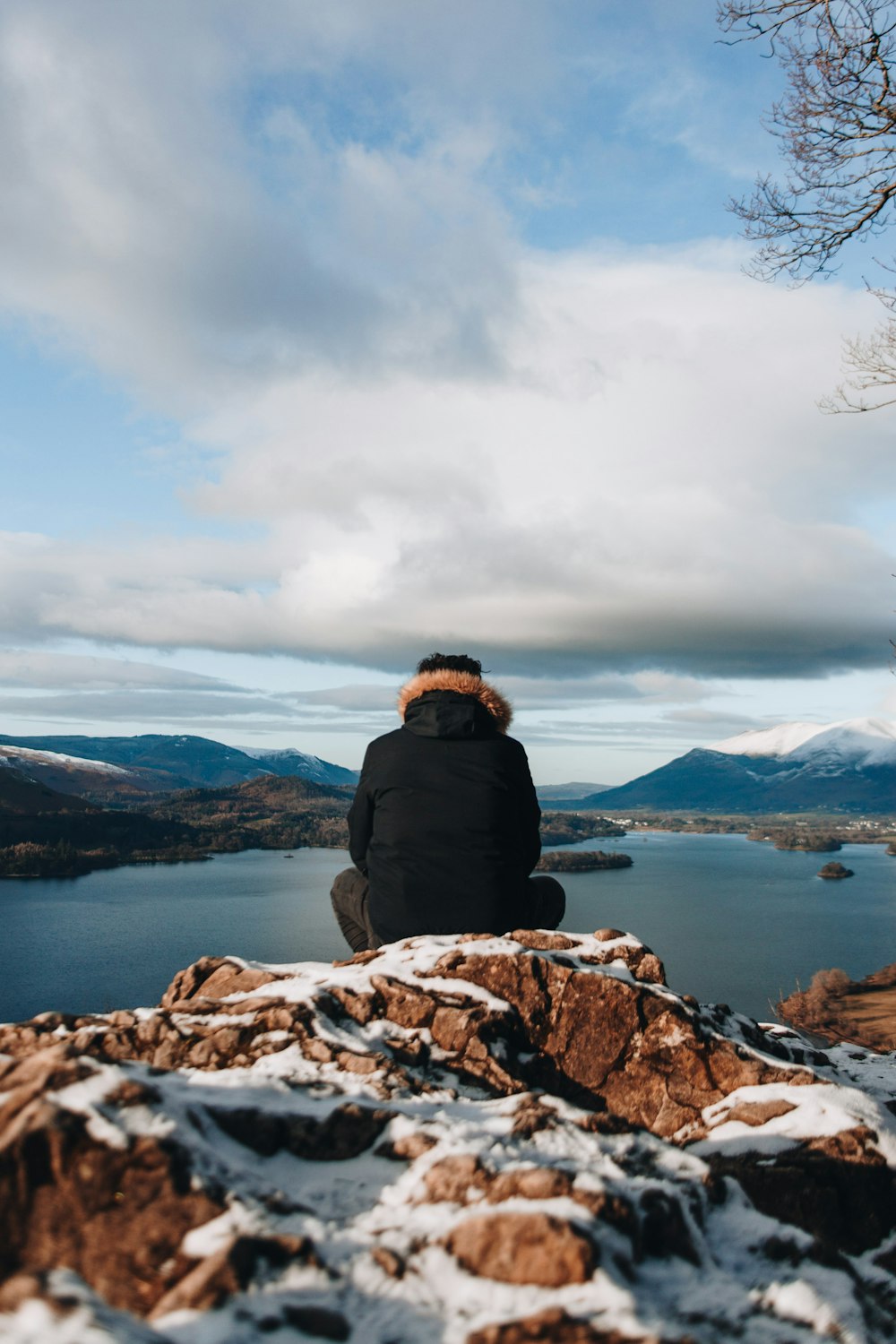 man sitting on mountain peak