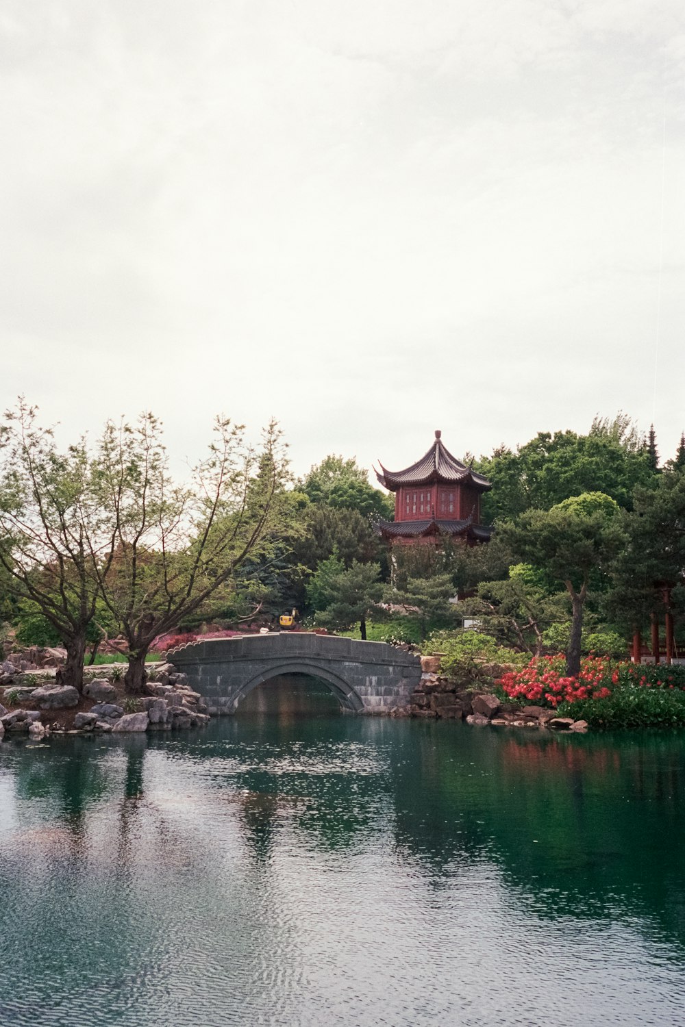 brown temple near bridge and body of water during daytime