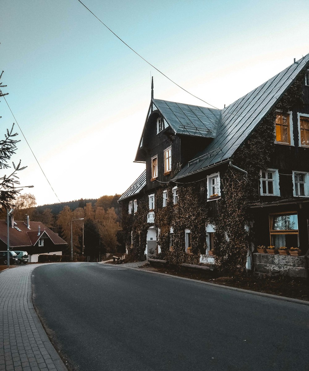 brown and gray house beside road during daytime