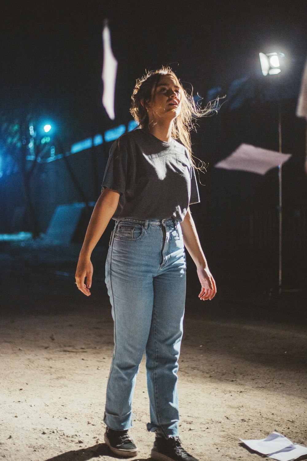 woman standing near lamp post during night time