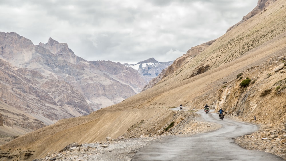 empty road near brown cliff