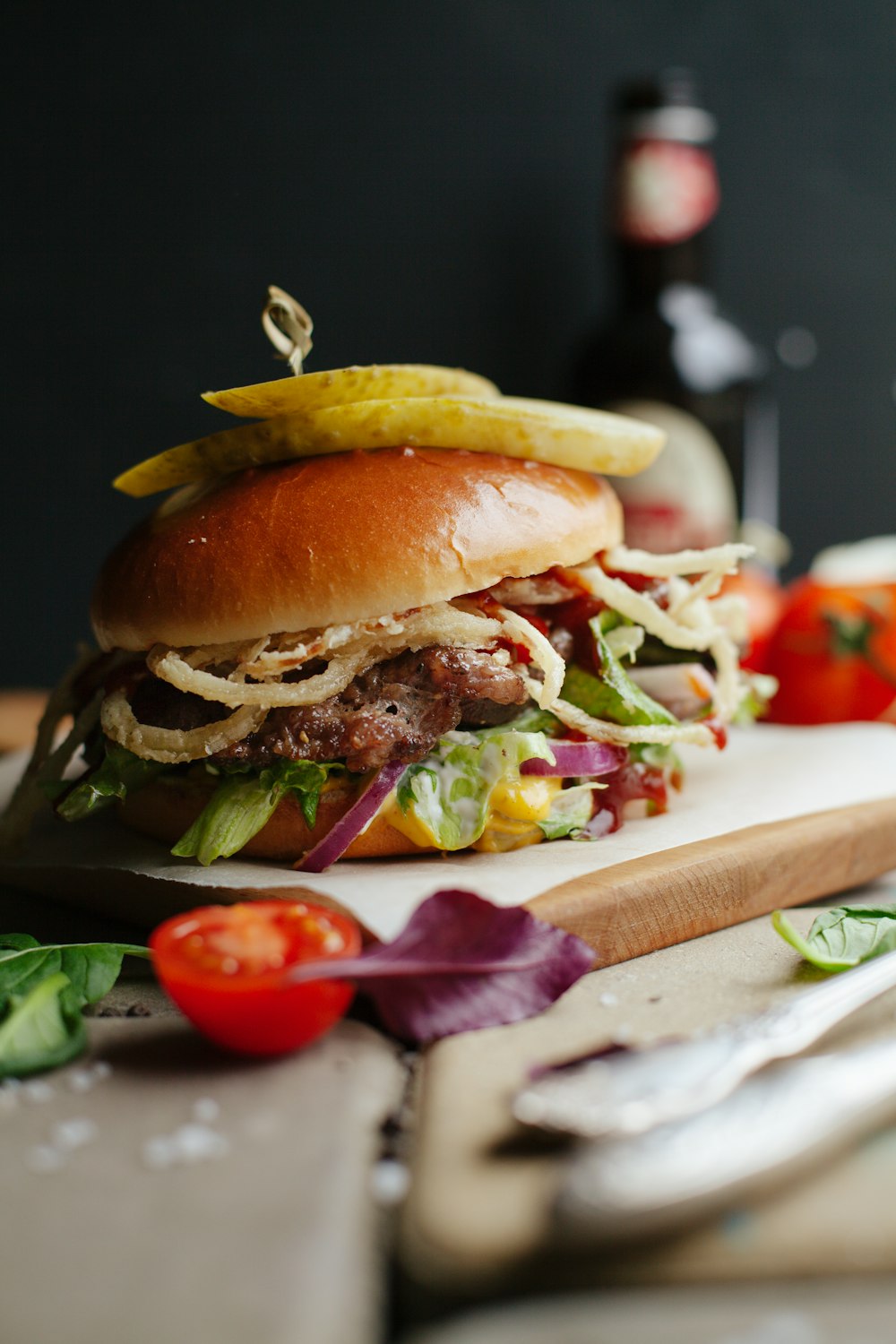 hamburger on brown wooden board in selective focus photography