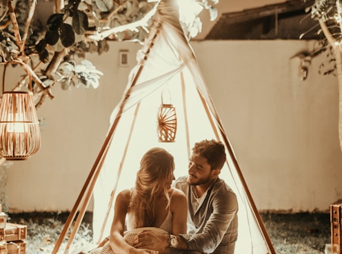 couple sitting inside tepee hut with lights onlyfans
